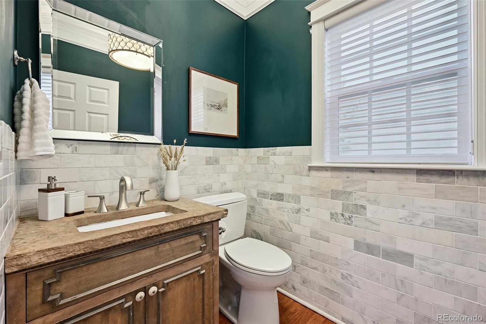 8741 East 33rd Avenue Denver, CO 80238 - Photo 31 of 43 a bathroom with a granite countertop toilet sink and mirror