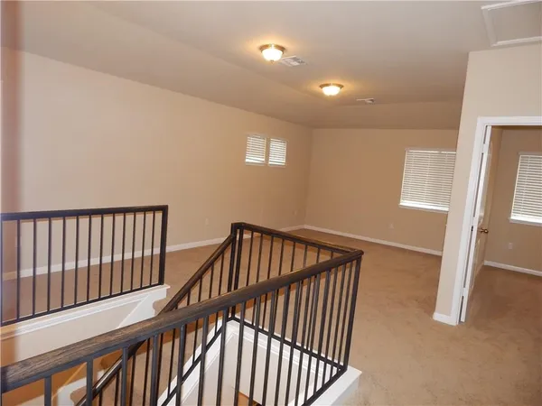 a view of staircase with white walls and a window