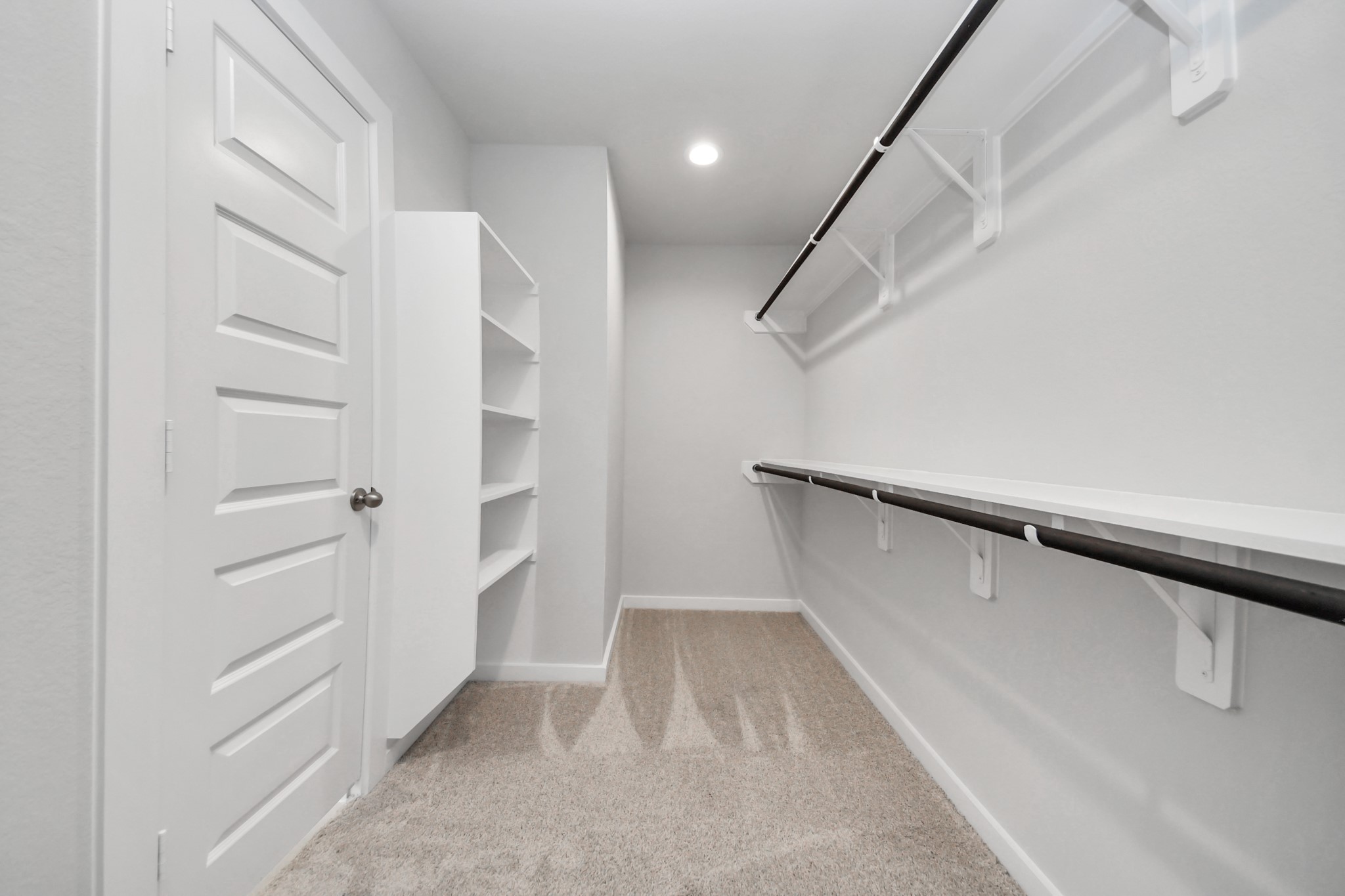 24518 Broad Park Spring, TX 77373 - Photo 26 of 29 Walk-in closet that epitomizes luxury and practicality. This generously sized space features built-in shelving, offering abundant room for impeccable organization. High ceilings and recessed lighting create a bright and welcoming ambiance. Sample photo of completed home with similar floor plan. Actual colors and selections may vary.