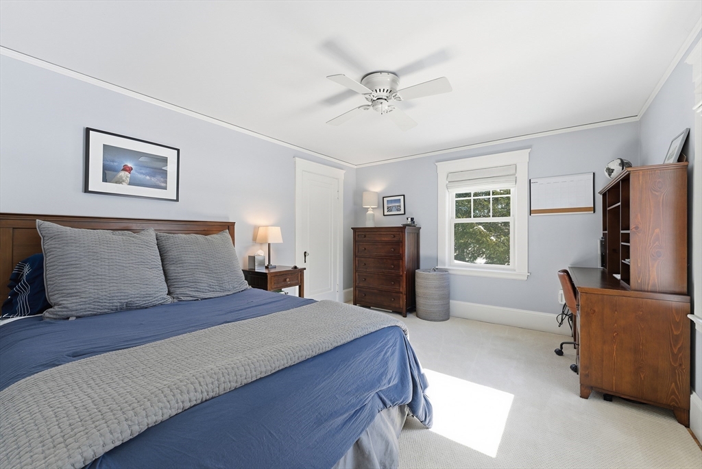 53 Prairie Street Concord, MA 01742 - Photo 12 of 26 a bedroom with a large bed and a flat screen television
