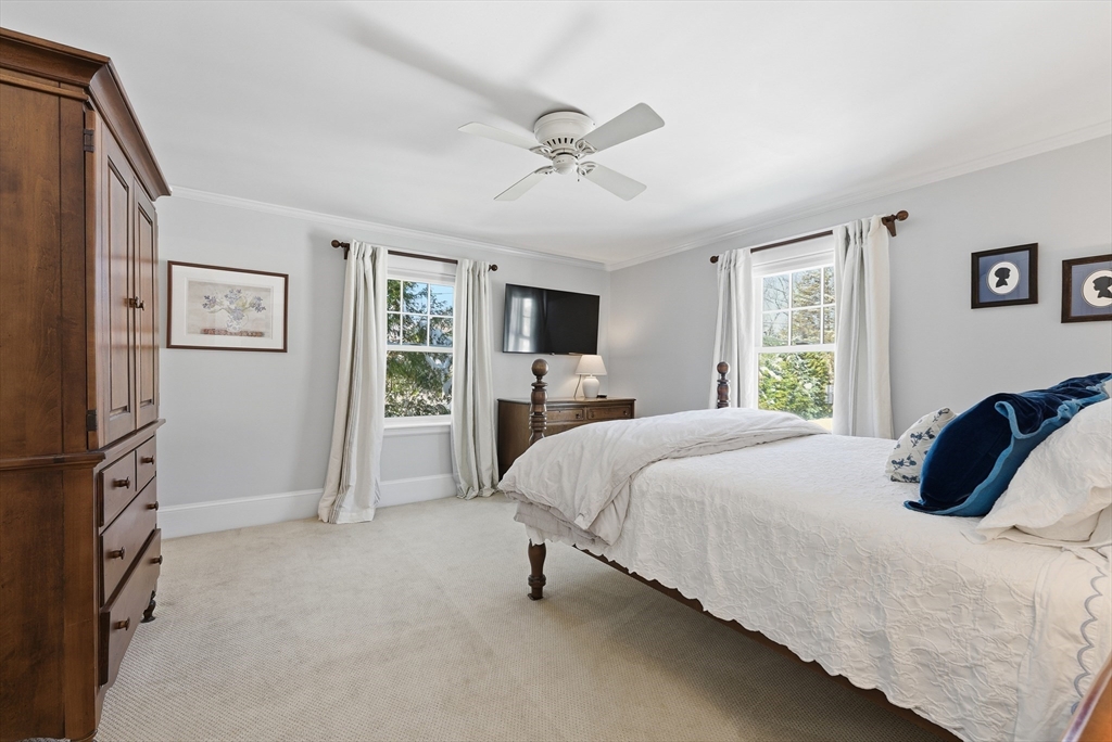 53 Prairie Street Concord, MA 01742 - Photo 13 of 26 a bedroom with a bed large window and a flat screen tv