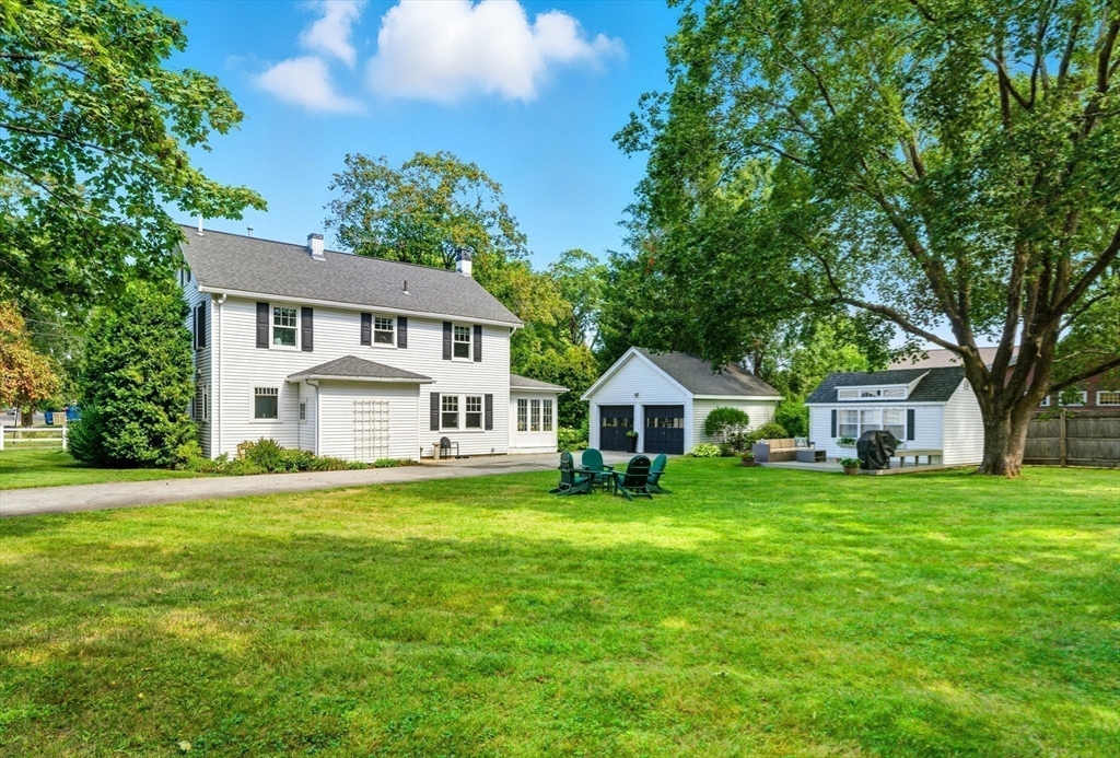 53 Prairie Street Concord, MA 01742 - Photo 21 of 26 a front view of a house with a garden