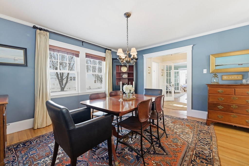 53 Prairie Street Concord, MA 01742 - Photo 6 of 26 a dining room with furniture a chandelier and wooden floor