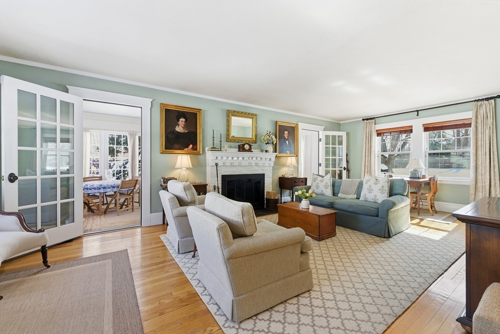 53 Prairie Street Concord, MA 01742 - Photo 7 of 26 a living room with furniture a large window and a fireplace