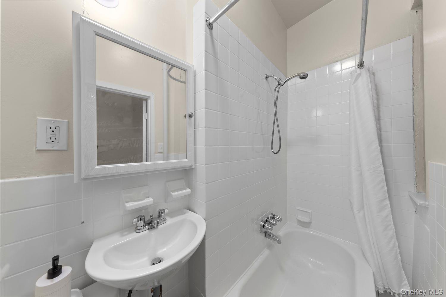 1777 Madison Avenue, Unit 32 Manhattan, NY 10035 - Photo 14 of 15 Bathroom featuring shower / bath combo and tile walls