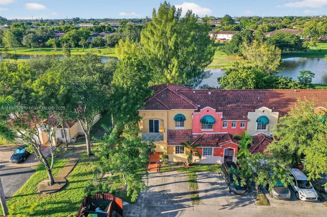 an aerial view of a house with a yard