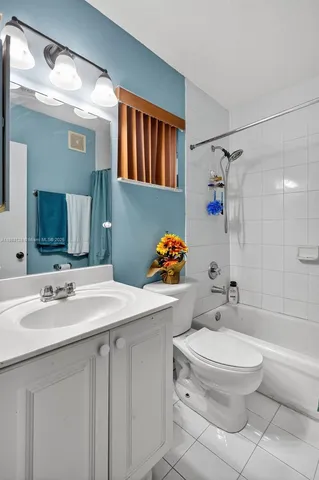 a bathroom with a sink toilet vanity and shower