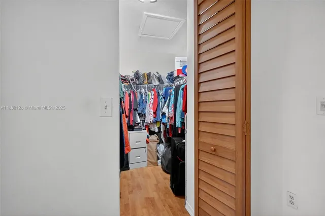 a view of walk in closet with clothes