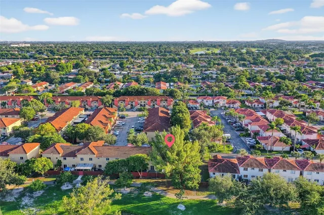 an aerial view of residential houses with outdoor space