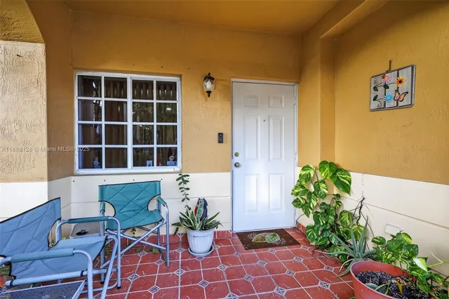 a front view of a house with potted plants
