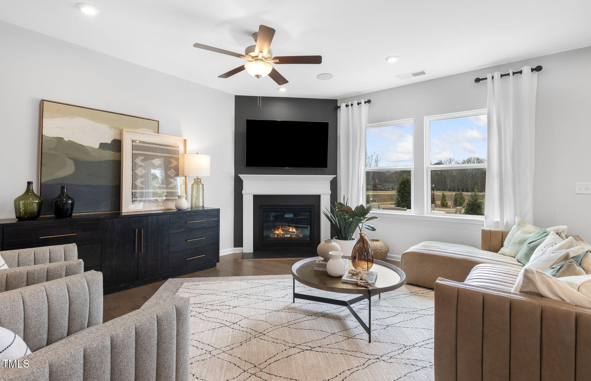 345 Brookside Drive Raleigh, NC 27603 - Photo 6 of 10 a living room with furniture a flat screen tv and a fireplace