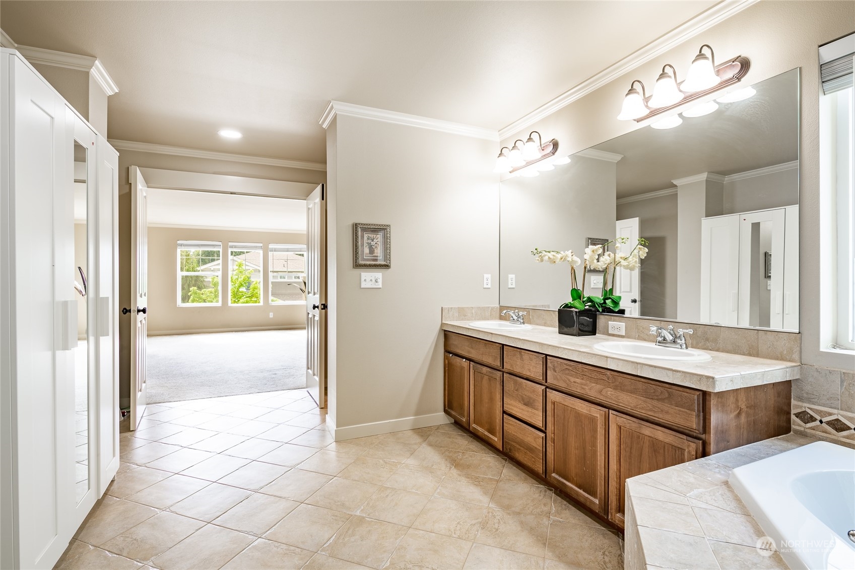 22831 36th Drive Southeast Bothell, WA 98021 - Photo 25 of 40 a spacious bathroom with a mirror a double vanity sink and a mirror