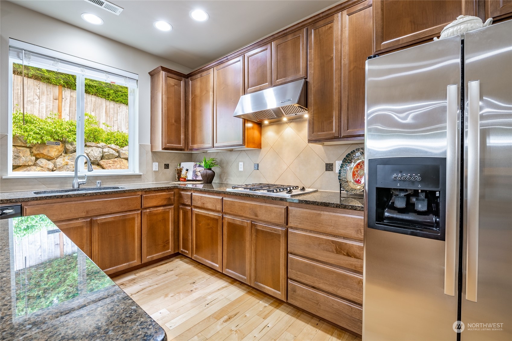 22831 36th Drive Southeast Bothell, WA 98021 - Photo 7 of 40 a kitchen with granite countertop a refrigerator and a sink