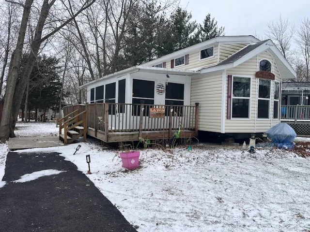 a white house that has a tree in front of it