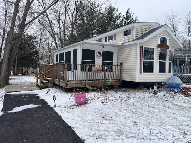 a white house that has a tree in front of it