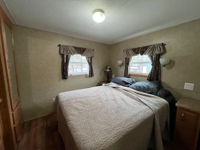 a bedroom with a bed and a mirror