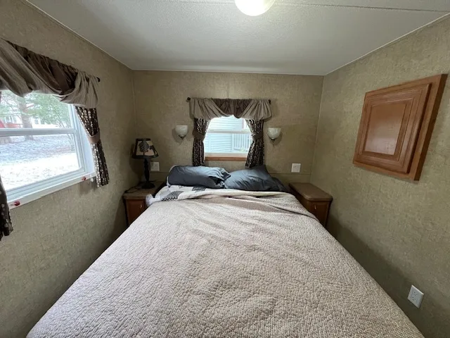 a bedroom with a bed and a window