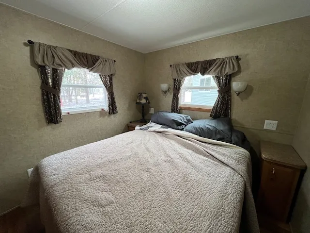 a bedroom with a bed and window