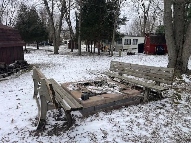 a front view of a house with a yard covered with trees
