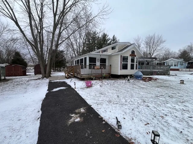 a front view of a house with a yard covered in snow