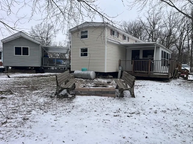 a view of a house with a yard covered in snow