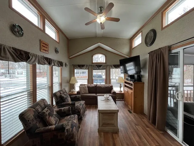 a living room with furniture a fireplace and a chandelier