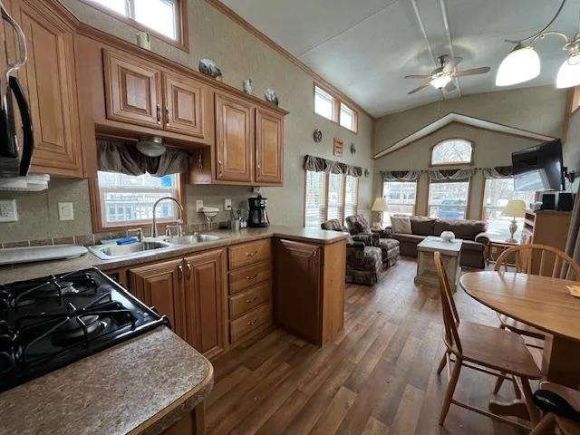 a kitchen with cabinets appliances and a dining table
