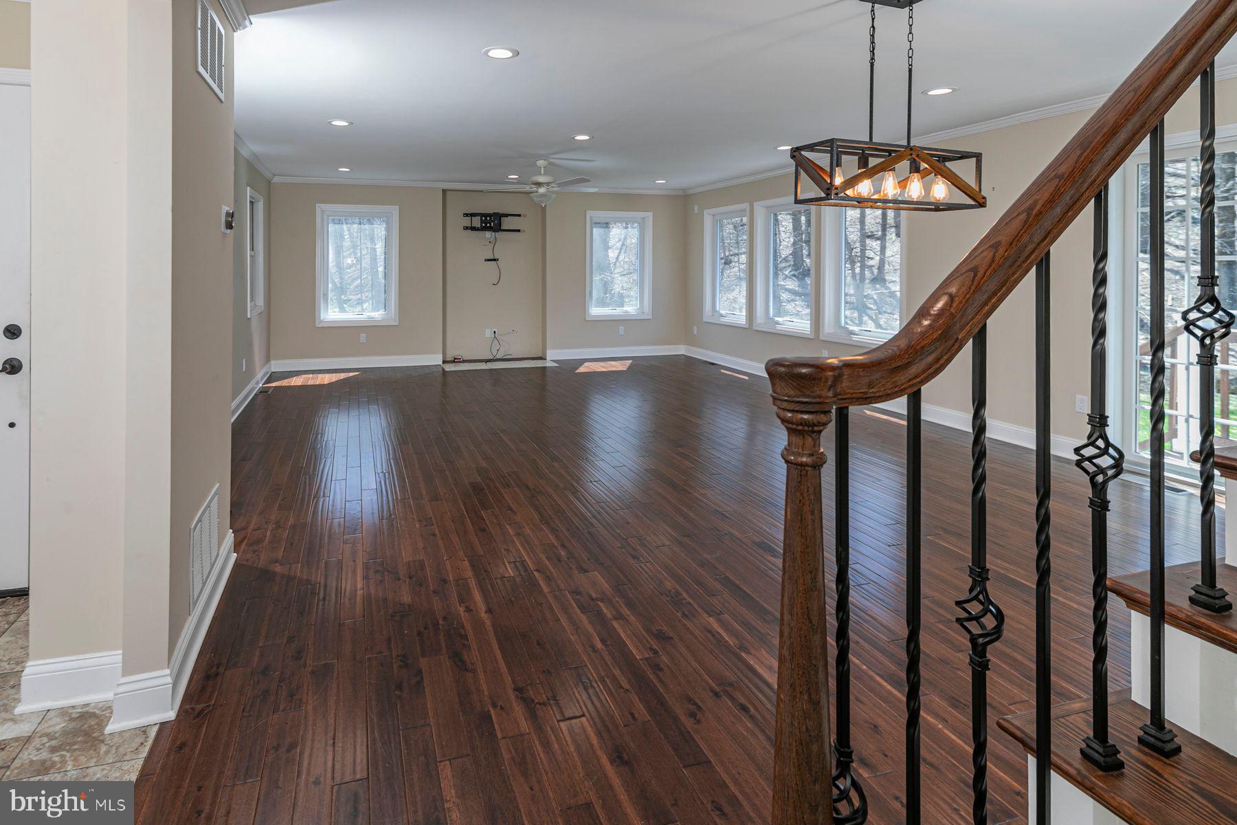 310 Hollow Road Skillman, NJ 08558 - Photo 5 of 32 a view of an entryway with wooden floor stairs and a chandelier