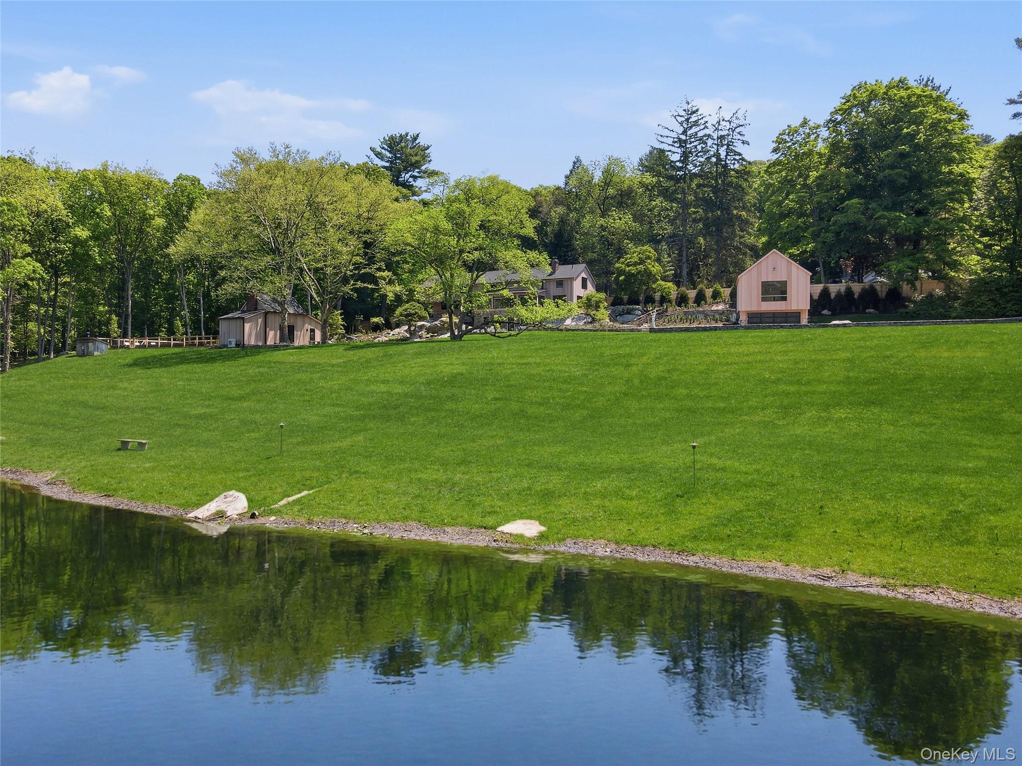 39 Old Snake Hill Road Pound Ridge, NY 10576 - Photo 5 of 37 a view of a lake with houses in back