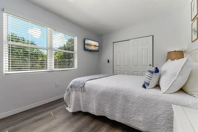 a bedroom with a large bed and a window