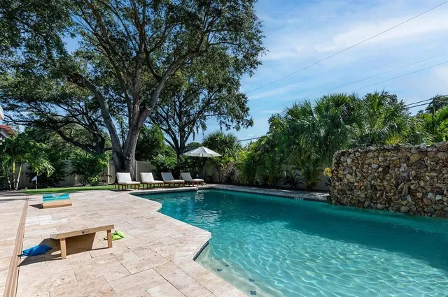 a view of a backyard with sitting area