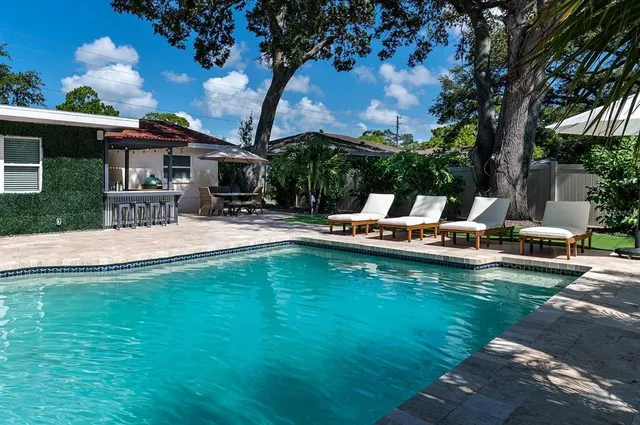 a view of a house with a backyard