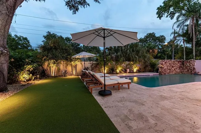 a view of a chairs and tables in the back yard of the house