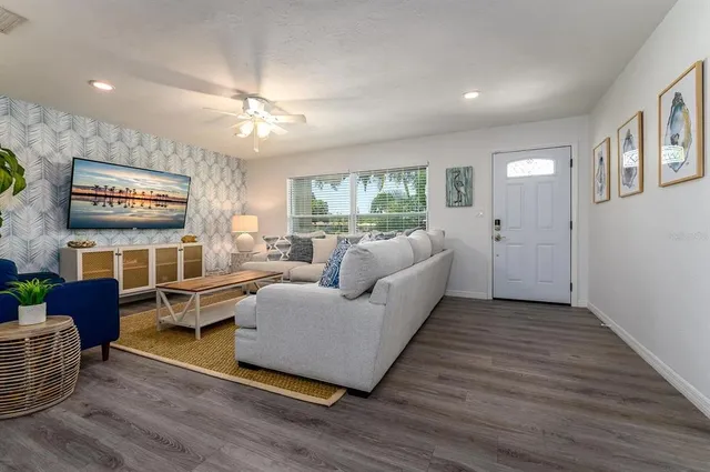 a kitchen with stainless steel appliances a refrigerator a sink a stove and white cabinets