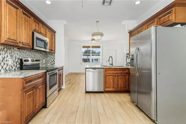 a kitchen with a sink stove and refrigerator