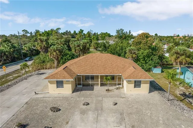 a view of a house with a backyard and a garage