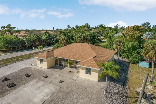an aerial view of a house with yard and mountain view in back