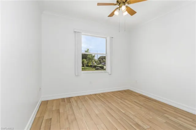 a view of a room with wooden floor and a window