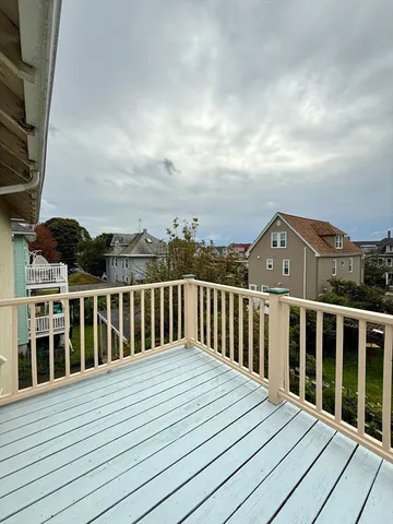 a view of balcony with wooden floor
