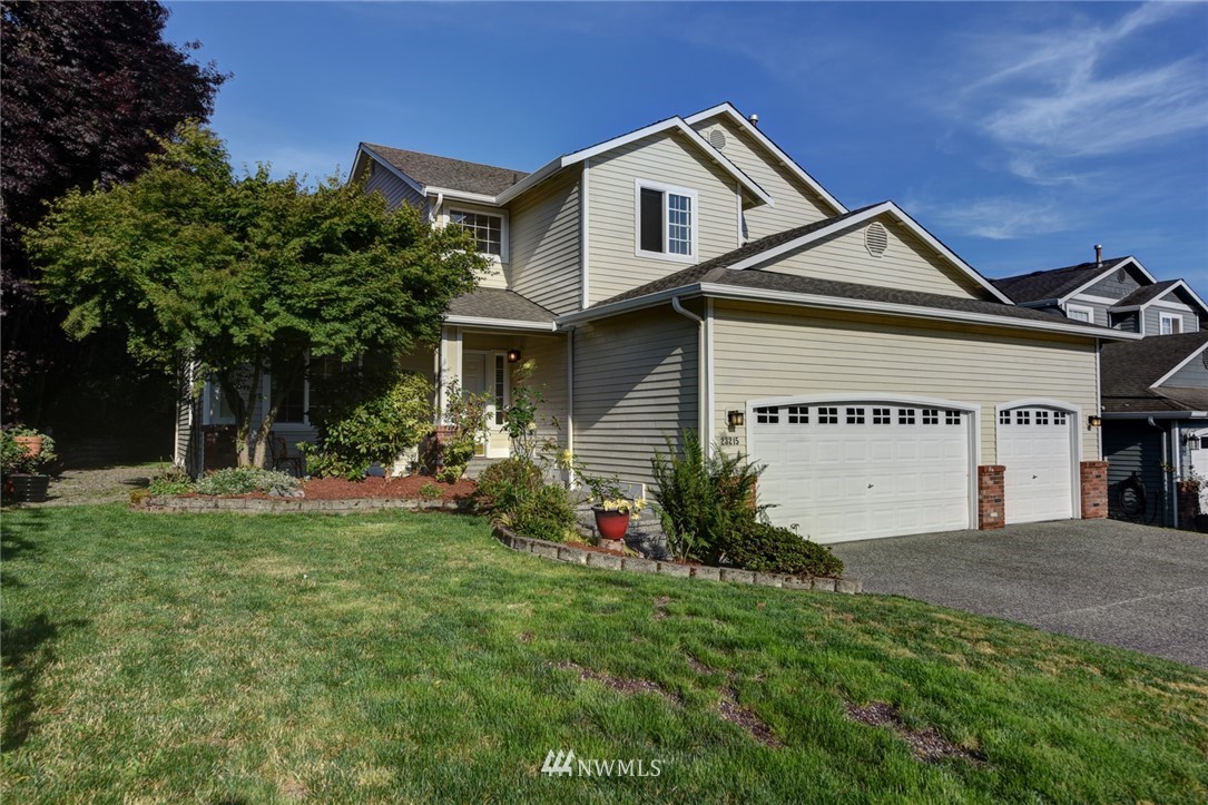 23215 9th Place West Bothell, WA 98021 - Photo 1 of 24 a front view of a house with a yard and garage