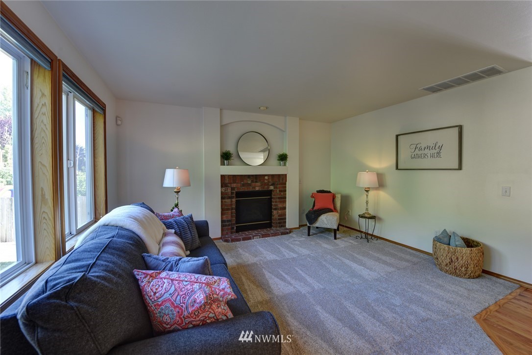 23215 9th Place West Bothell, WA 98021 - Photo 11 of 24 a living room with furniture and a fireplace