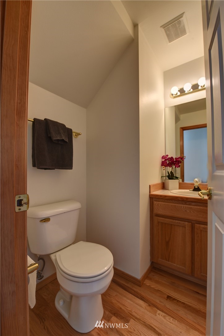 23215 9th Place West Bothell, WA 98021 - Photo 12 of 24 a bathroom with a toilet a sink and mirror