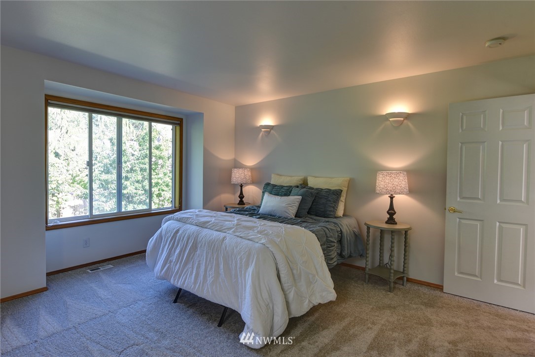 23215 9th Place West Bothell, WA 98021 - Photo 13 of 24 a bed room with a bed and a night stand