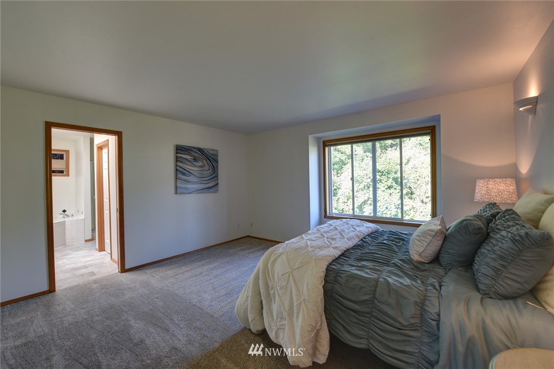 23215 9th Place West Bothell, WA 98021 - Photo 14 of 24 a bedroom with a bed and a window