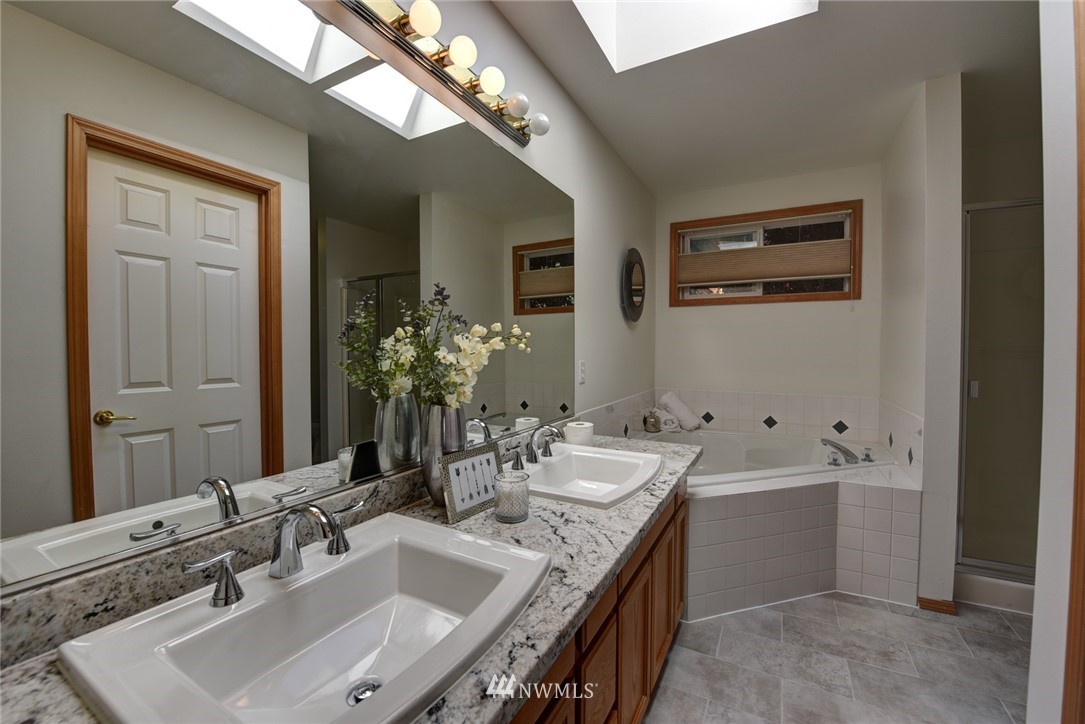 23215 9th Place West Bothell, WA 98021 - Photo 15 of 24 a bathroom with a sink and a mirror