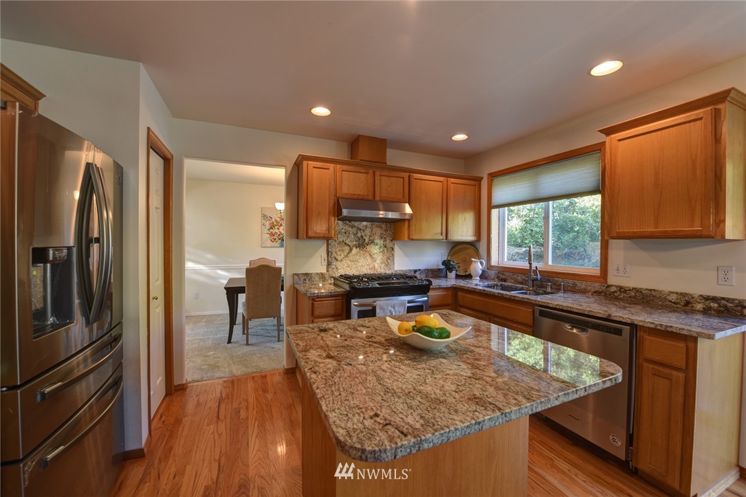 23215 9th Place West Bothell, WA 98021 - Photo 9 of 24 a kitchen with stainless steel appliances granite countertop sink refrigerator and microwave