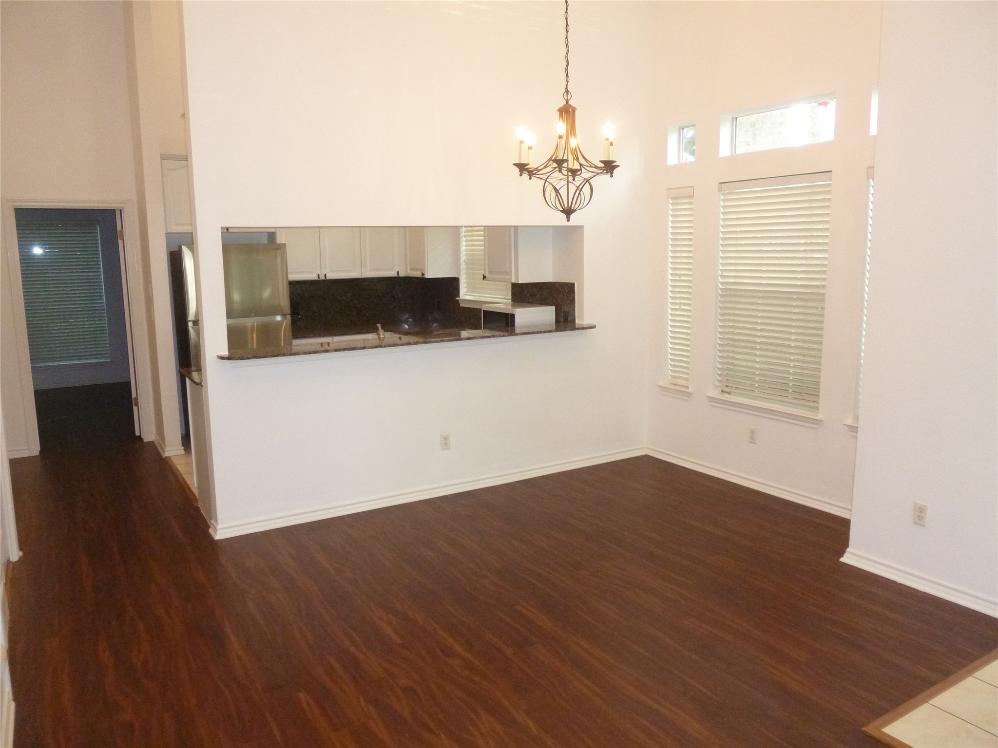 2918 Ranch Road 620 North, Unit Y194 Austin, TX 78734 - Photo 10 of 35 a view of a room with wooden floor and chandelier