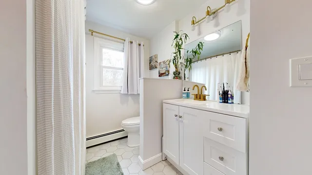 a bathroom with a toilet sink and mirror