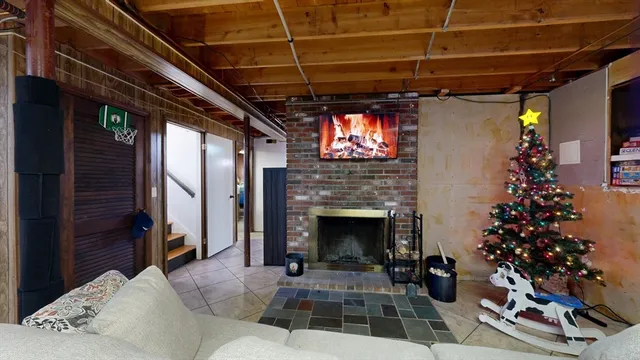 a living room with a potted plant and a fireplace