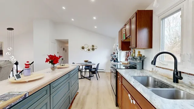 a kitchen with granite countertop a sink and cabinets